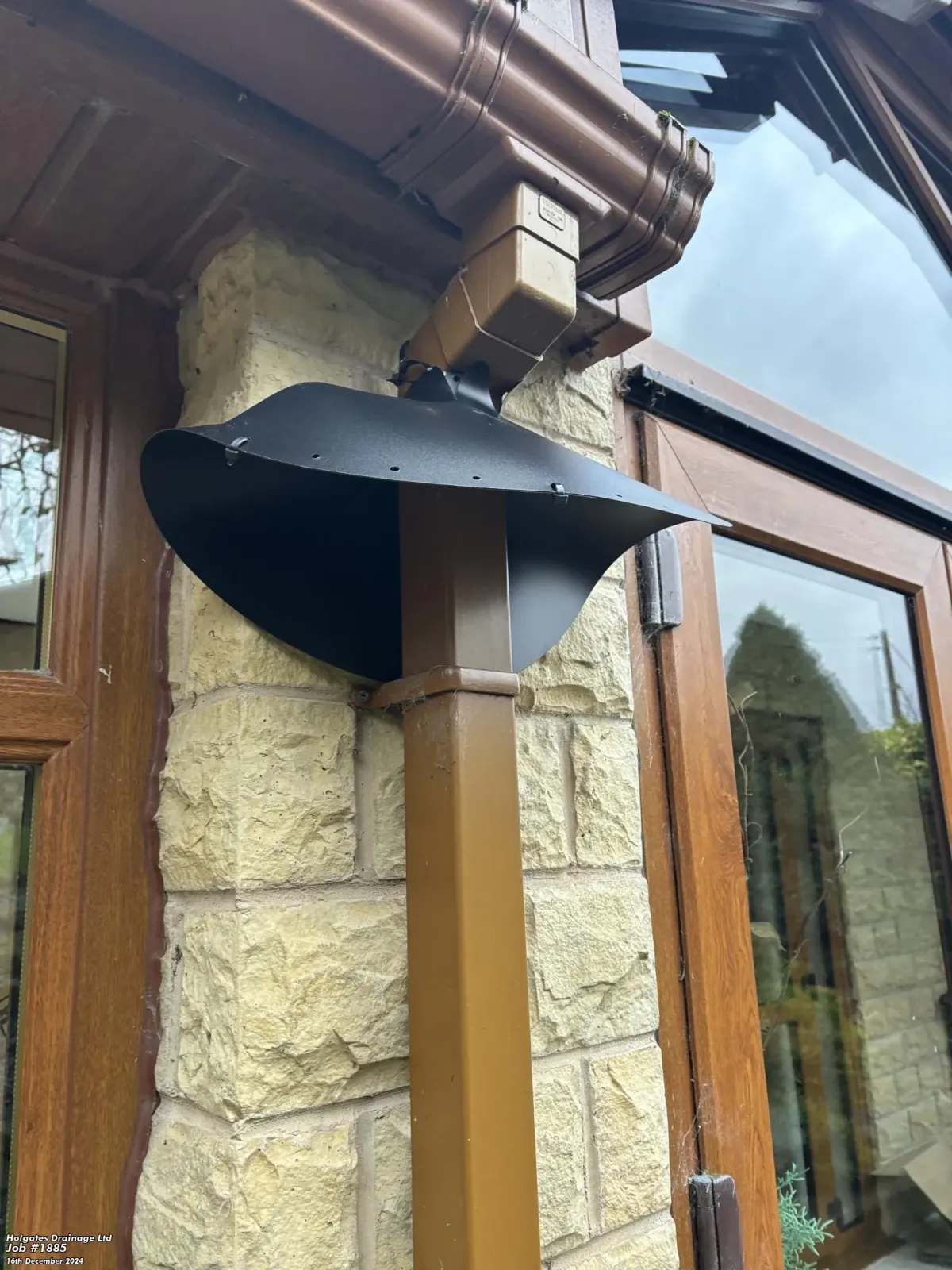 Professional rodent proofing installation showing a rat baffle on an external downpipe in Blackburn