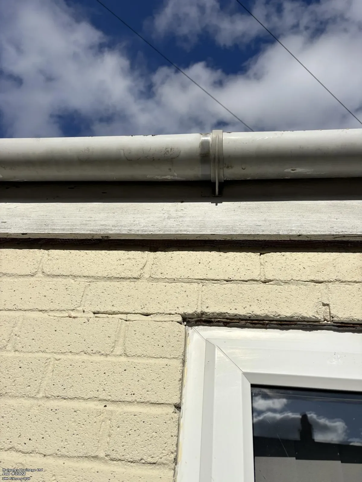 Rodent proofing mesh installed in a gap under the roofline of a brick house to prevent rats and mice entering.