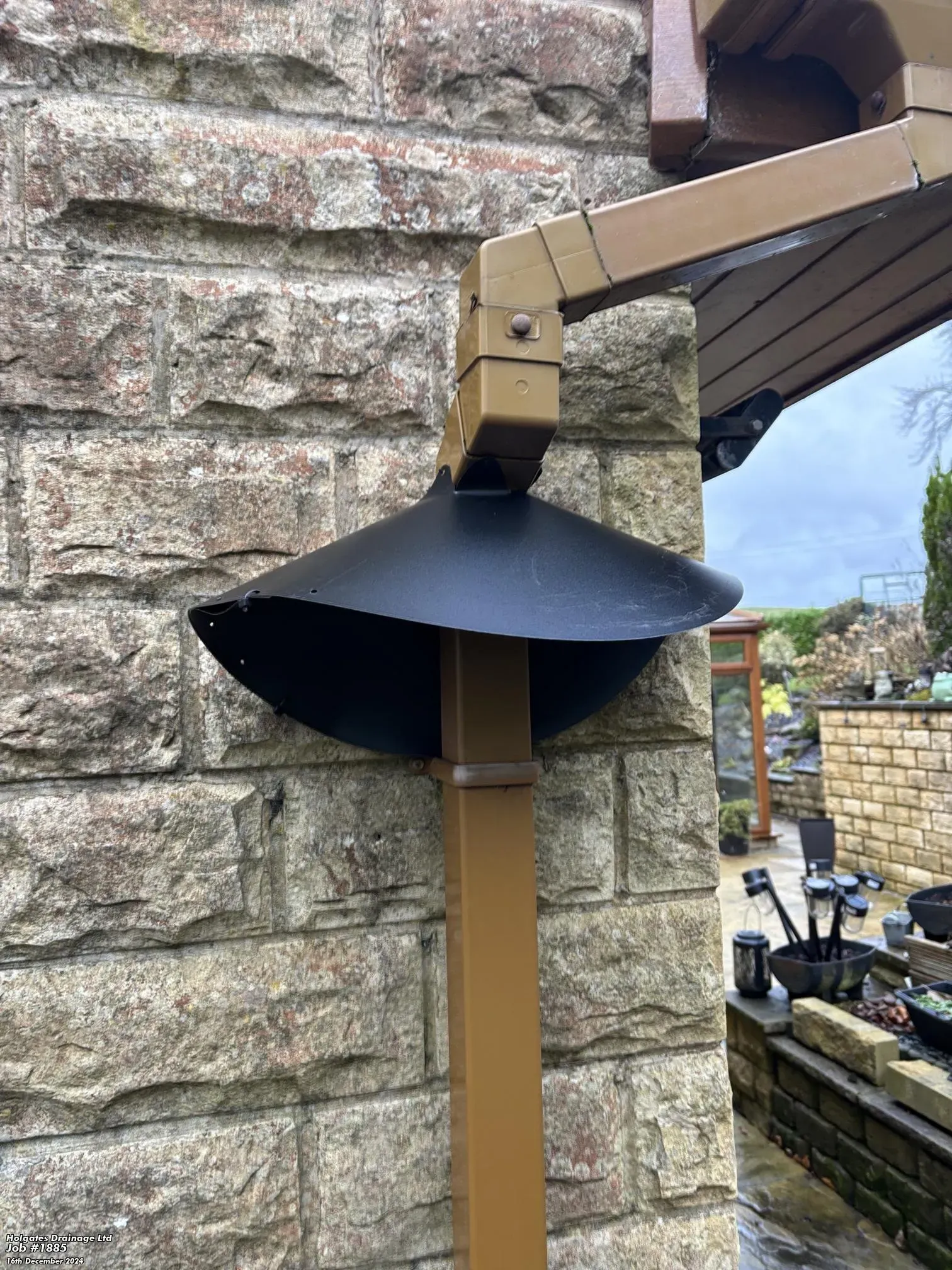 Rodent proofing cone baffle installed on an external downpipe to prevent pests climbing to the roof