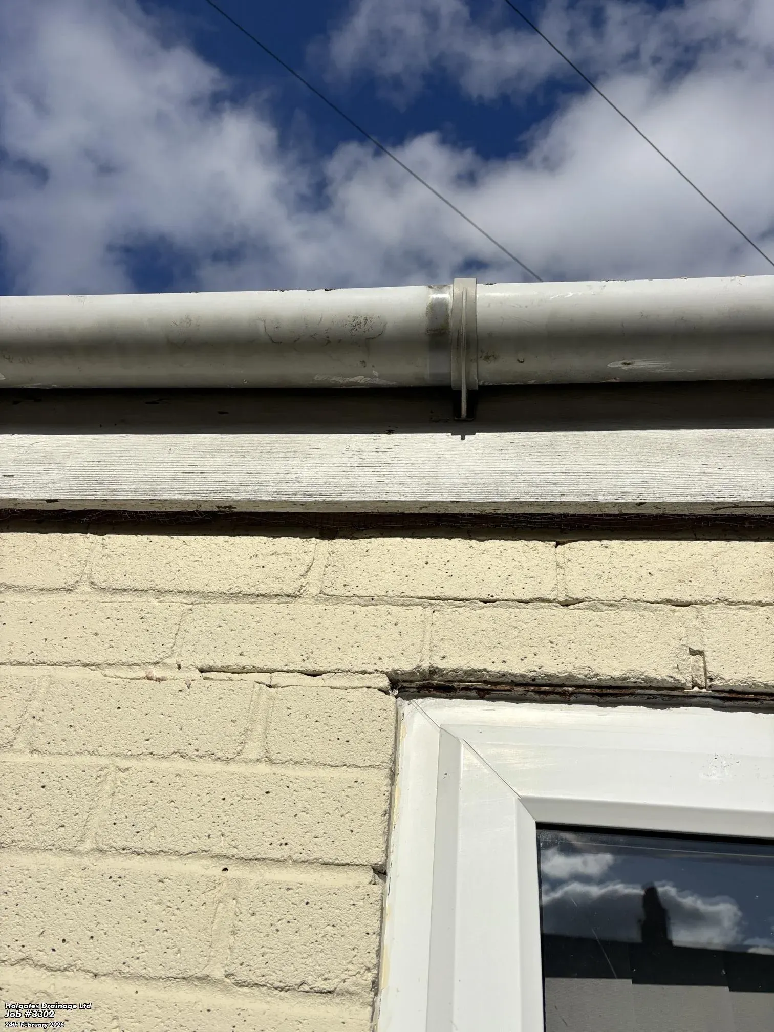 Rodent proofing mesh installed in a gap under the roofline of a brick house to prevent rats and mice entering.