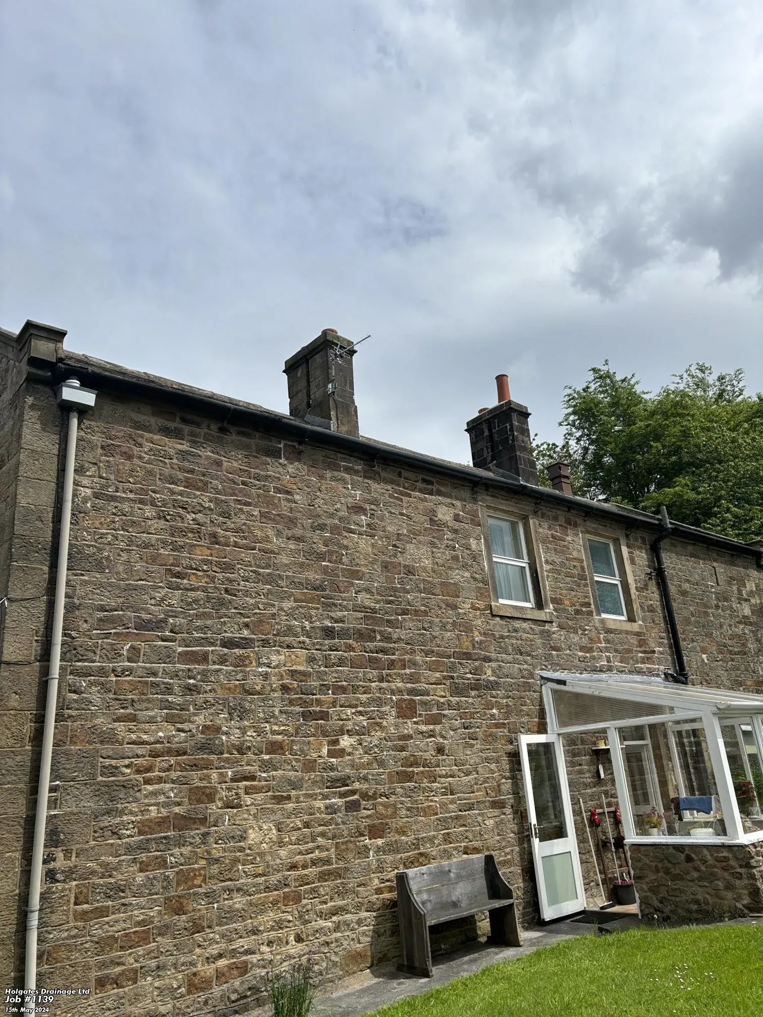 Exterior of a stone house in Blackburn, Lancashire, showing a conservatory and roofline, typical of properties serviced for rodent proofing and drain surveys by Pest Medic.