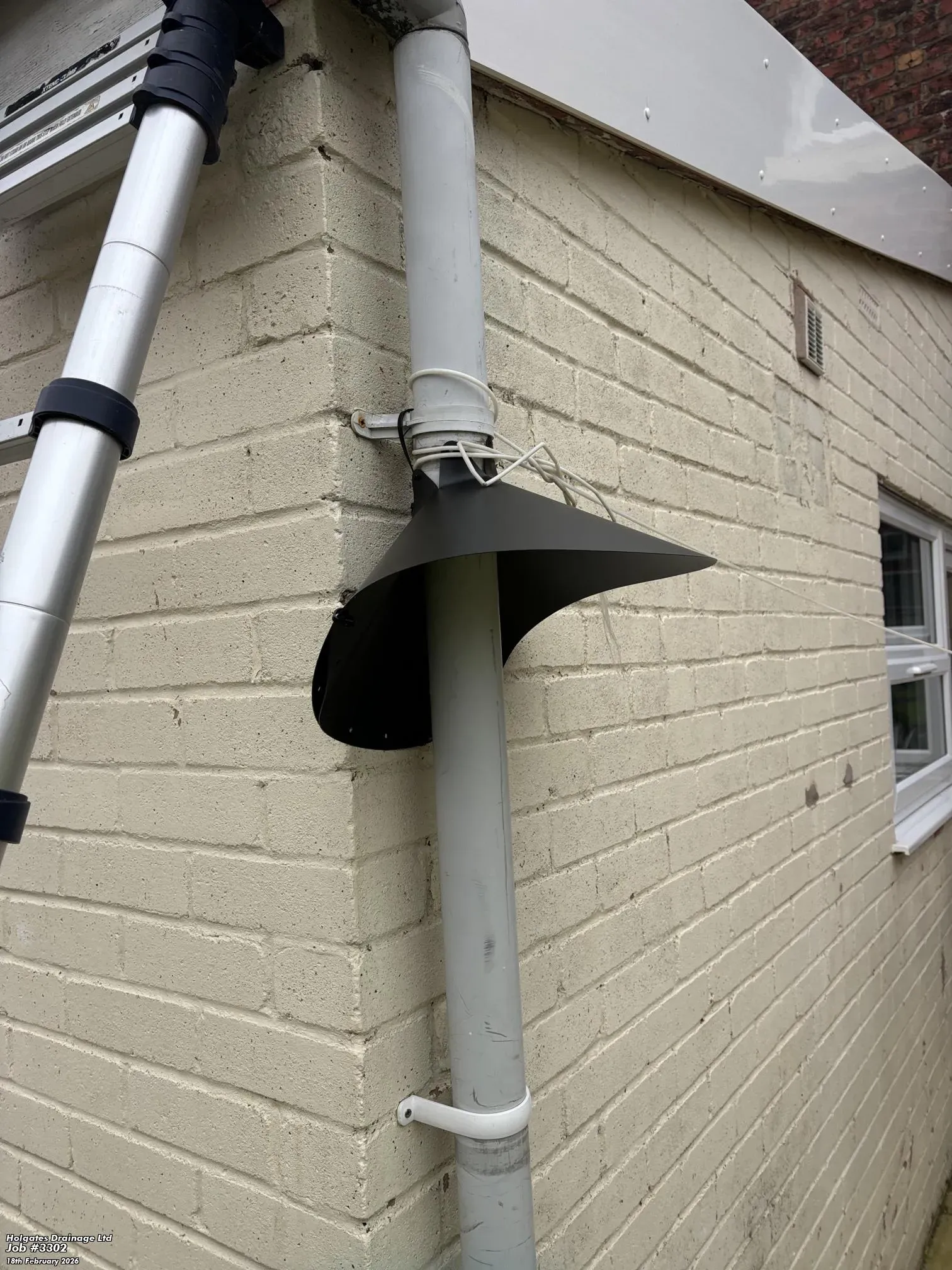 Rodent proofing cone installed on a white exterior pipe in Blackburn by Pest Medic.