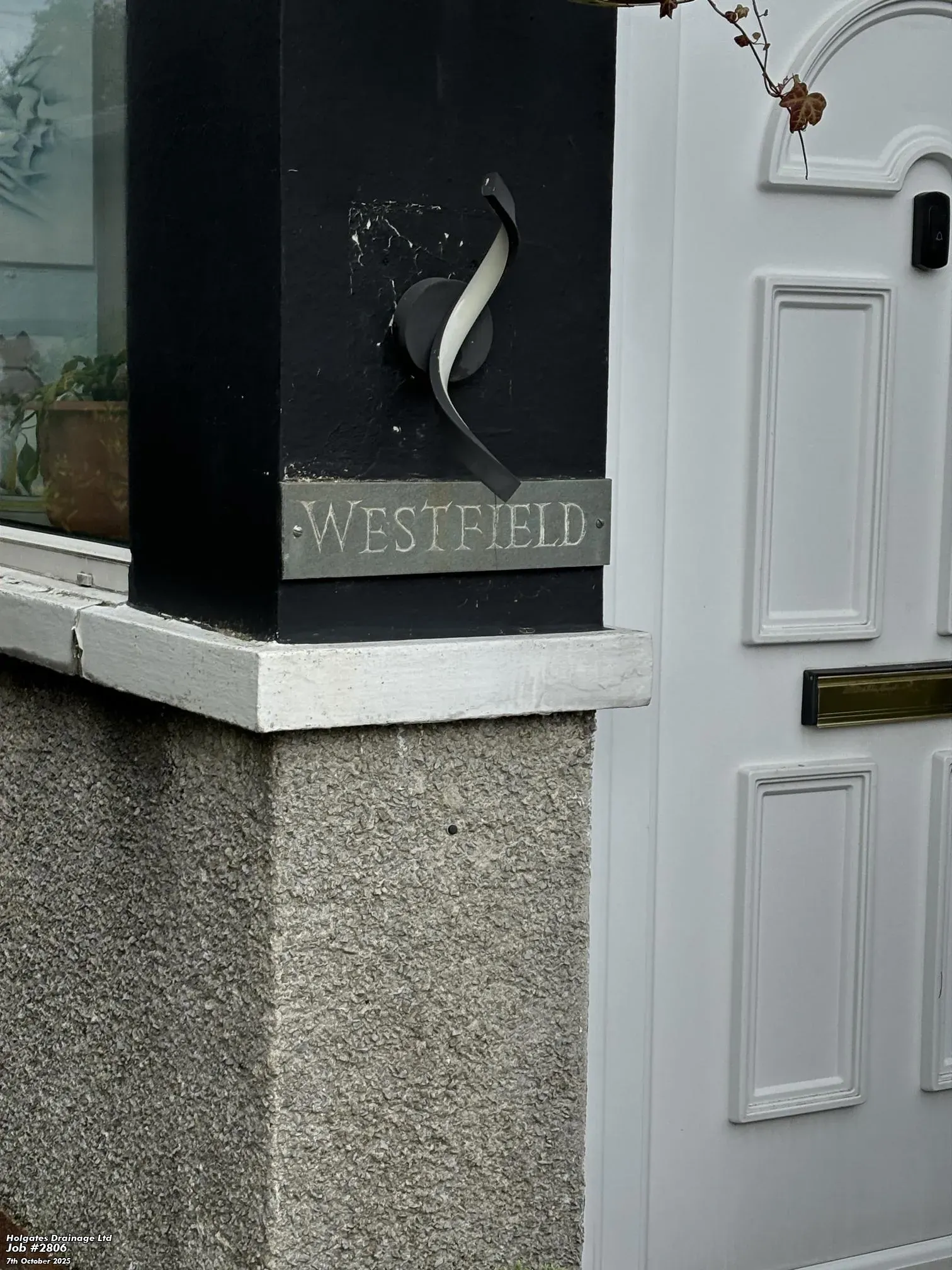 Exterior of a house in Blackburn named Westfield during a drainage inspection for rodent control.
