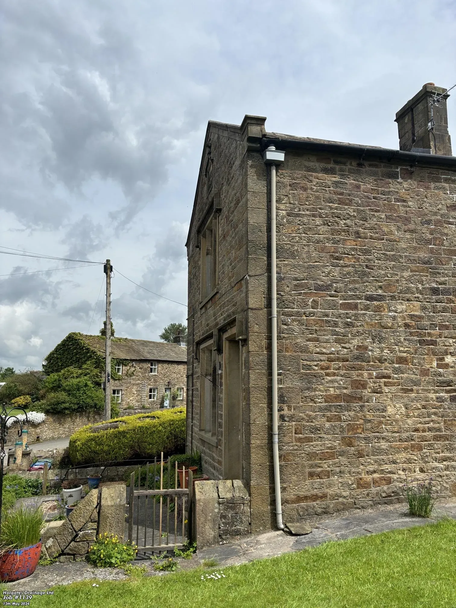 Traditional stone house in Lancashire showing external walls and drainage, a common site for rodent proofing and pest control services.